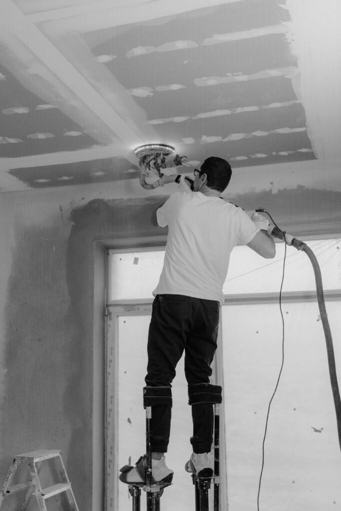 pexels photo 6474349 6474349 Professional polish a ceiling in a black and white construction site setting.